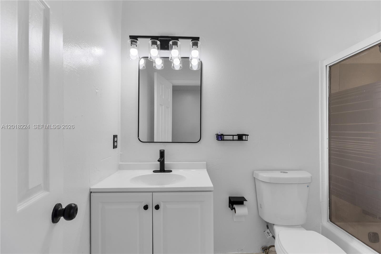 7958 Southwest 6th Street Pompano Beach, FL 33068 - Photo 36 of 57 a bathroom with a toilet sink and mirror