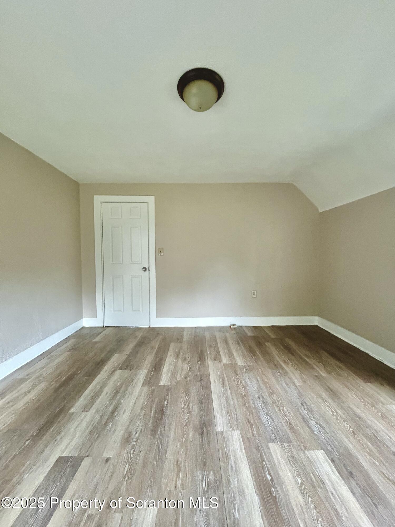 1393 1395 Old Trail Road, Unit 2 Clarks Summit, PA 18411 - Photo 13 of 15 a view of an empty room and wooden floor