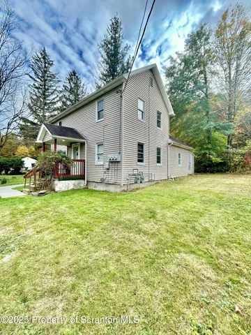 a view of a house with backyard and sitting area