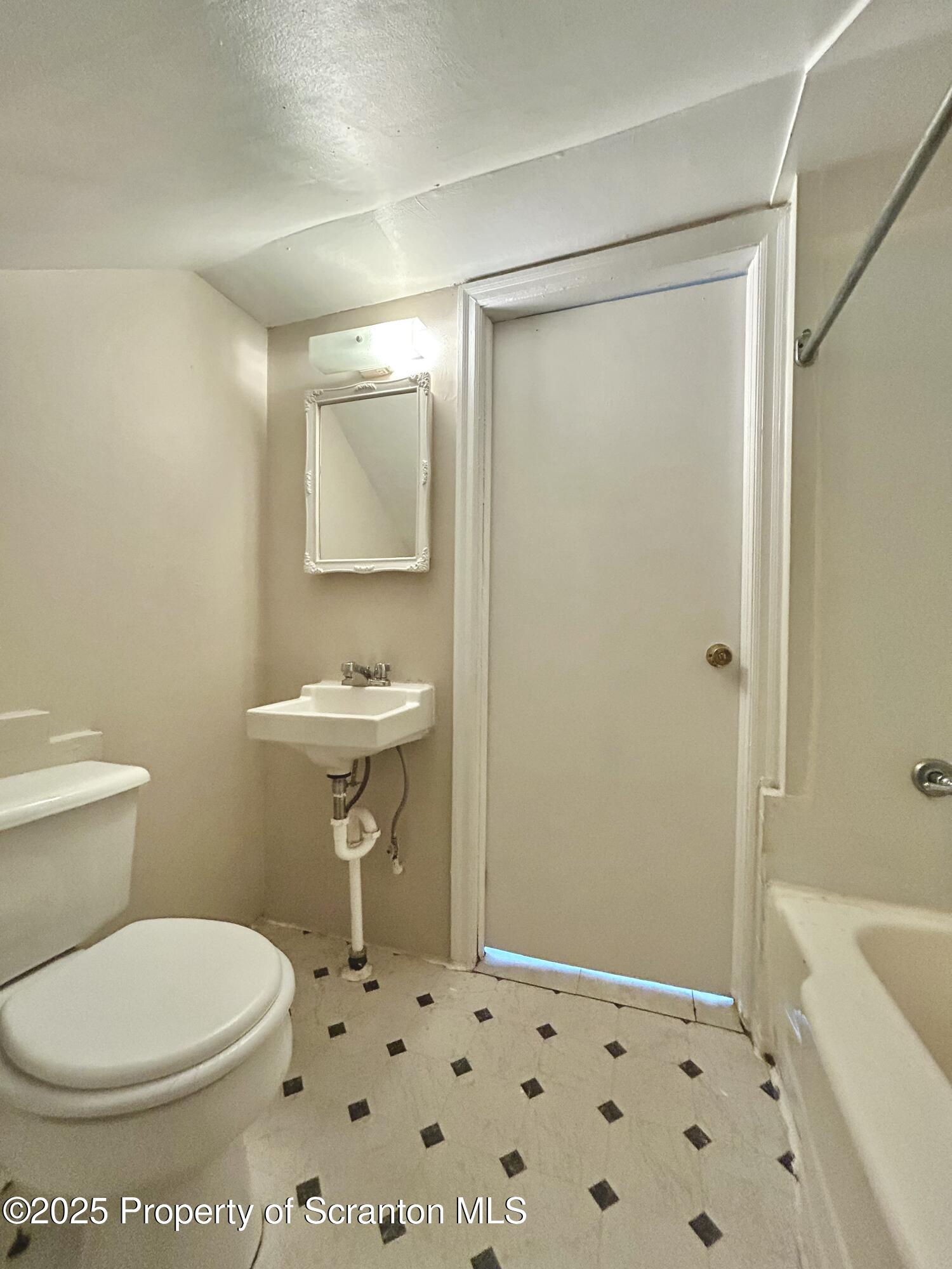 1393 1395 Old Trail Road, Unit 2 Clarks Summit, PA 18411 - Photo 9 of 15 a bathroom with a toilet sink and shower