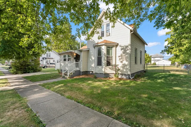 a front view of house with yard and green space