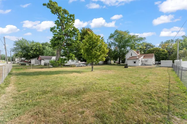 a house view with swimming pool in front of it