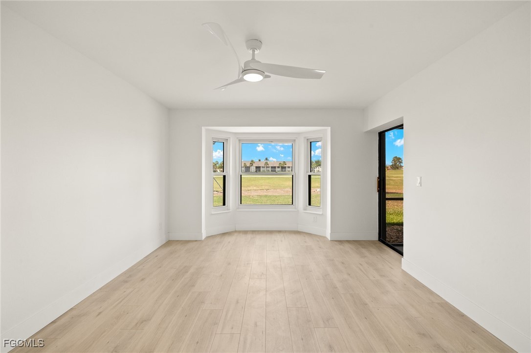 16260 Kelly Cove Drive, Unit 235 Fort Myers, FL 33908 - Photo 16 of 30 wooden floor in an empty room with a window