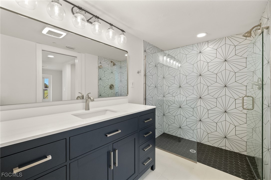 16260 Kelly Cove Drive, Unit 235 Fort Myers, FL 33908 - Photo 20 of 30 a bathroom with a sink and a mirror