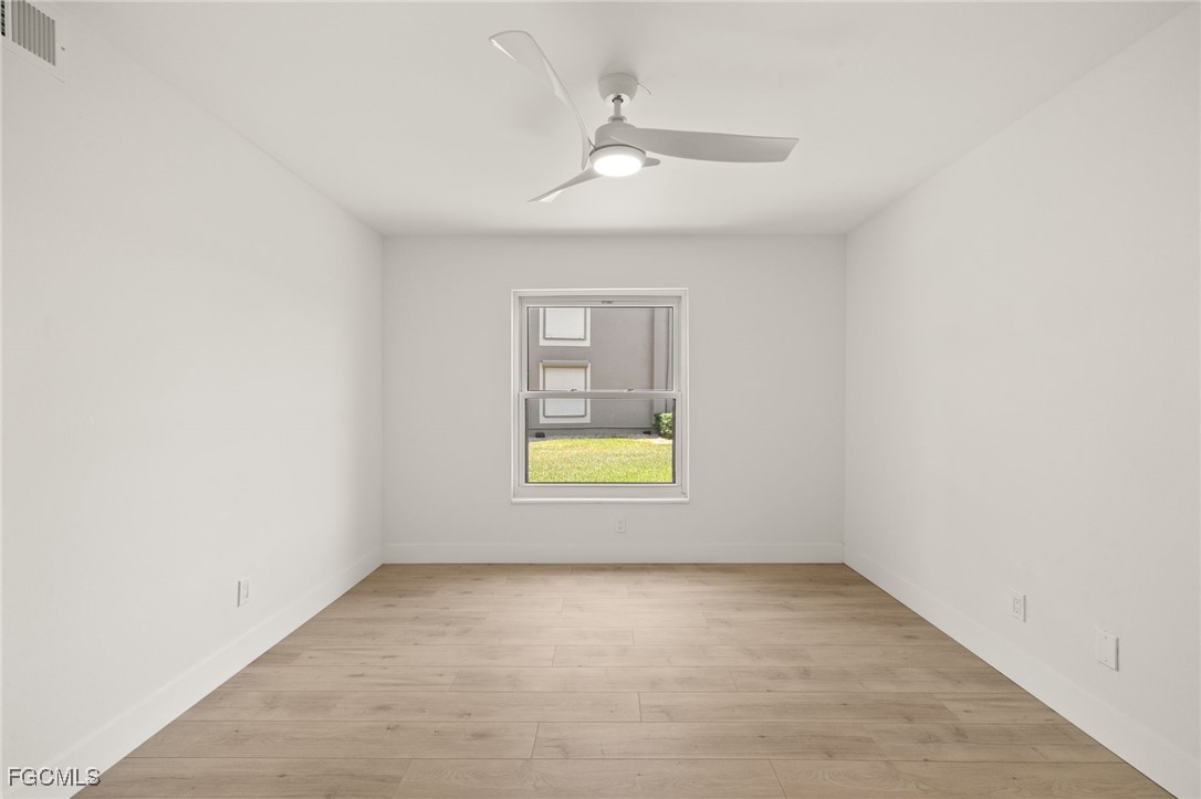 16260 Kelly Cove Drive, Unit 235 Fort Myers, FL 33908 - Photo 22 of 30 an empty room with a window and a ceiling fan