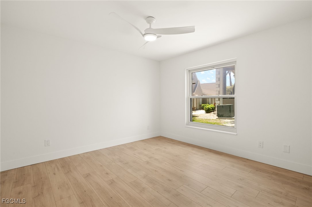 16260 Kelly Cove Drive, Unit 235 Fort Myers, FL 33908 - Photo 24 of 30 an empty room with a window and a ceiling fan