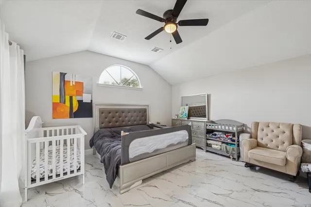 a bedroom with a large bed and a couch