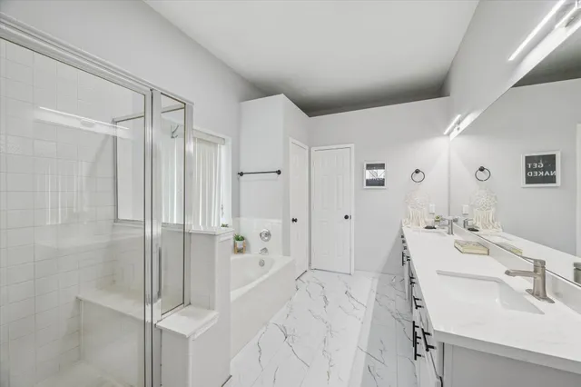 a spacious bathroom with a shower sink and mirror