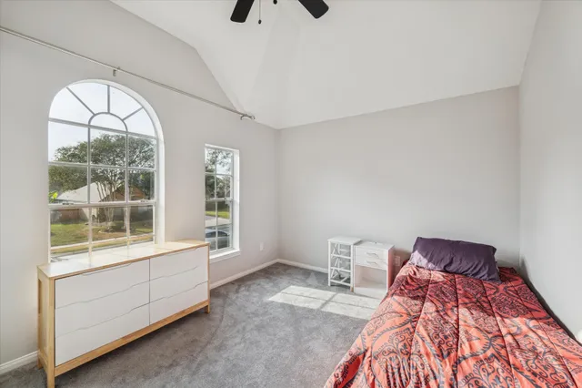 a bed room with a bed and a window