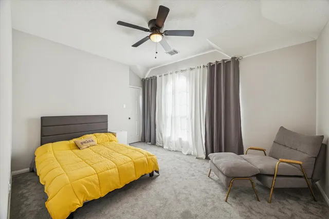 a bedroom with a bed and chair