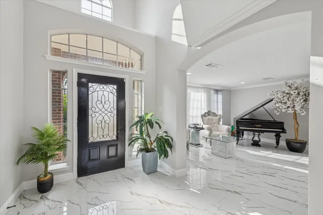 a view of living room filled with furniture and a potted plant