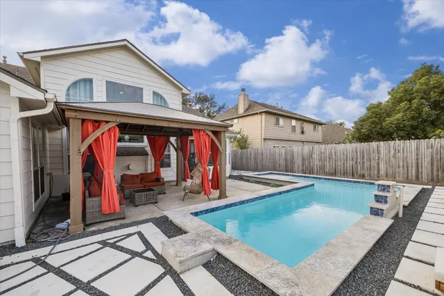 a view of a house with wooden floor and a barbeque