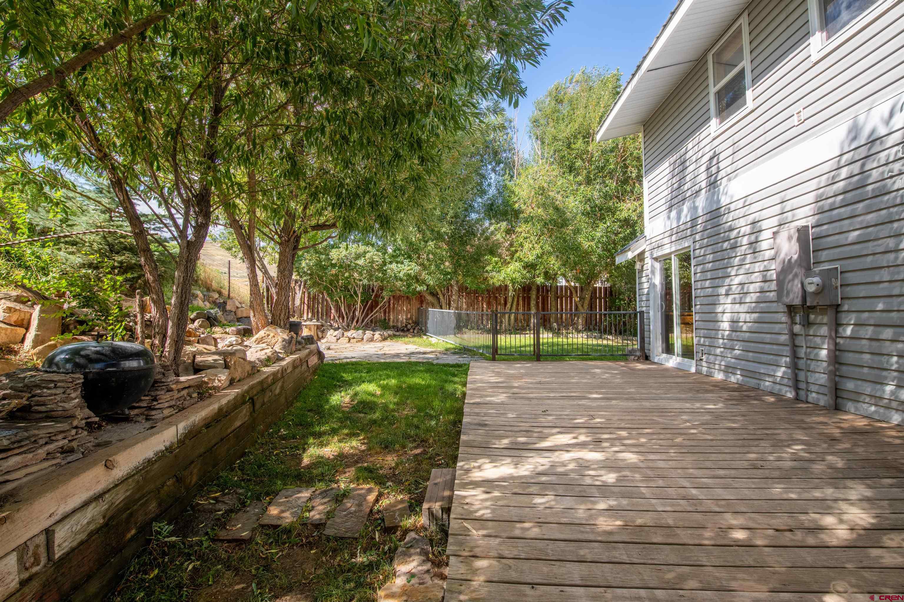 15 Debby Way Gunnison, CO 81230 - Photo 12 of 34 a view of a yard with plants and a large tree