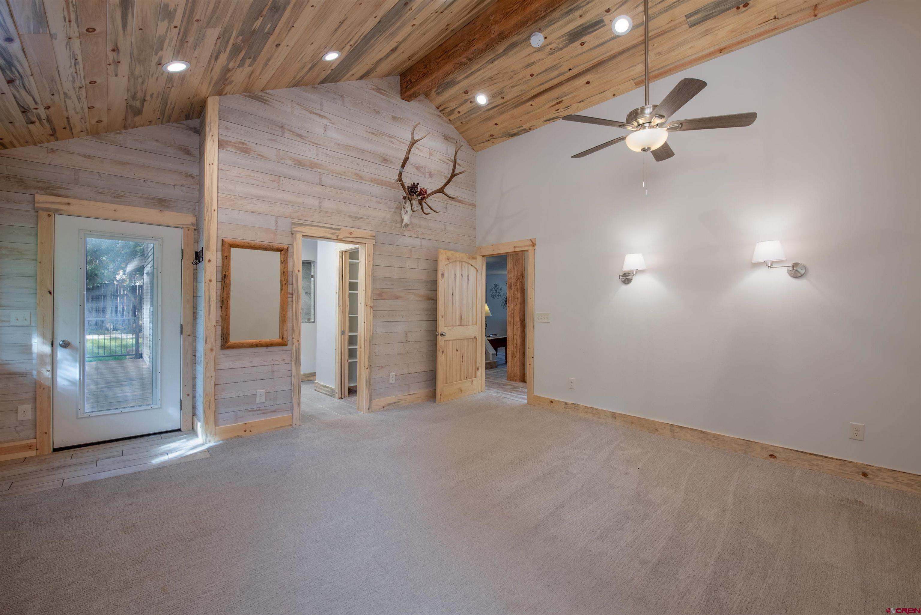 15 Debby Way Gunnison, CO 81230 - Photo 17 of 34 an empty room with chandelier fan and windows