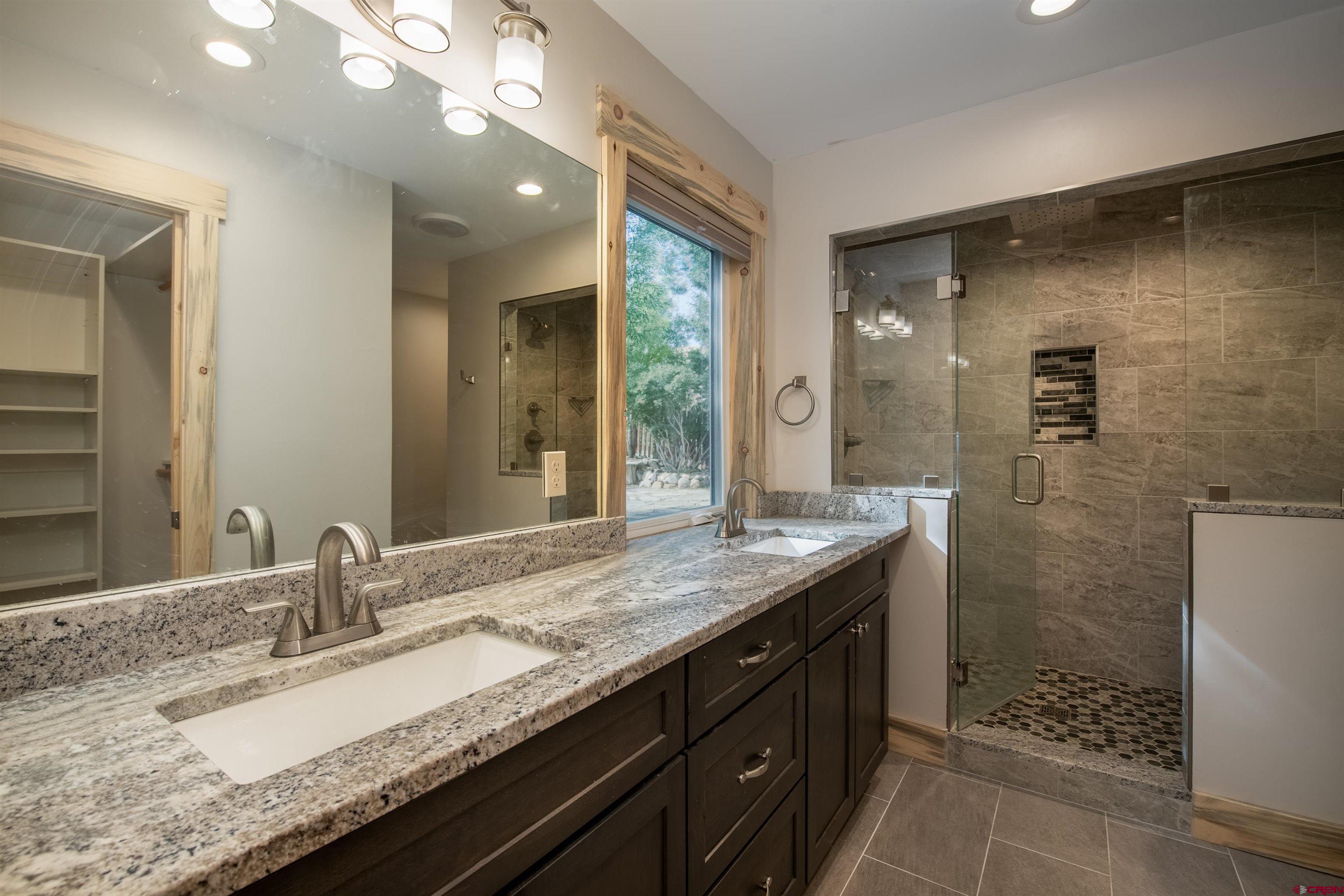 15 Debby Way Gunnison, CO 81230 - Photo 18 of 34 a bathroom with a granite countertop sink and a mirror