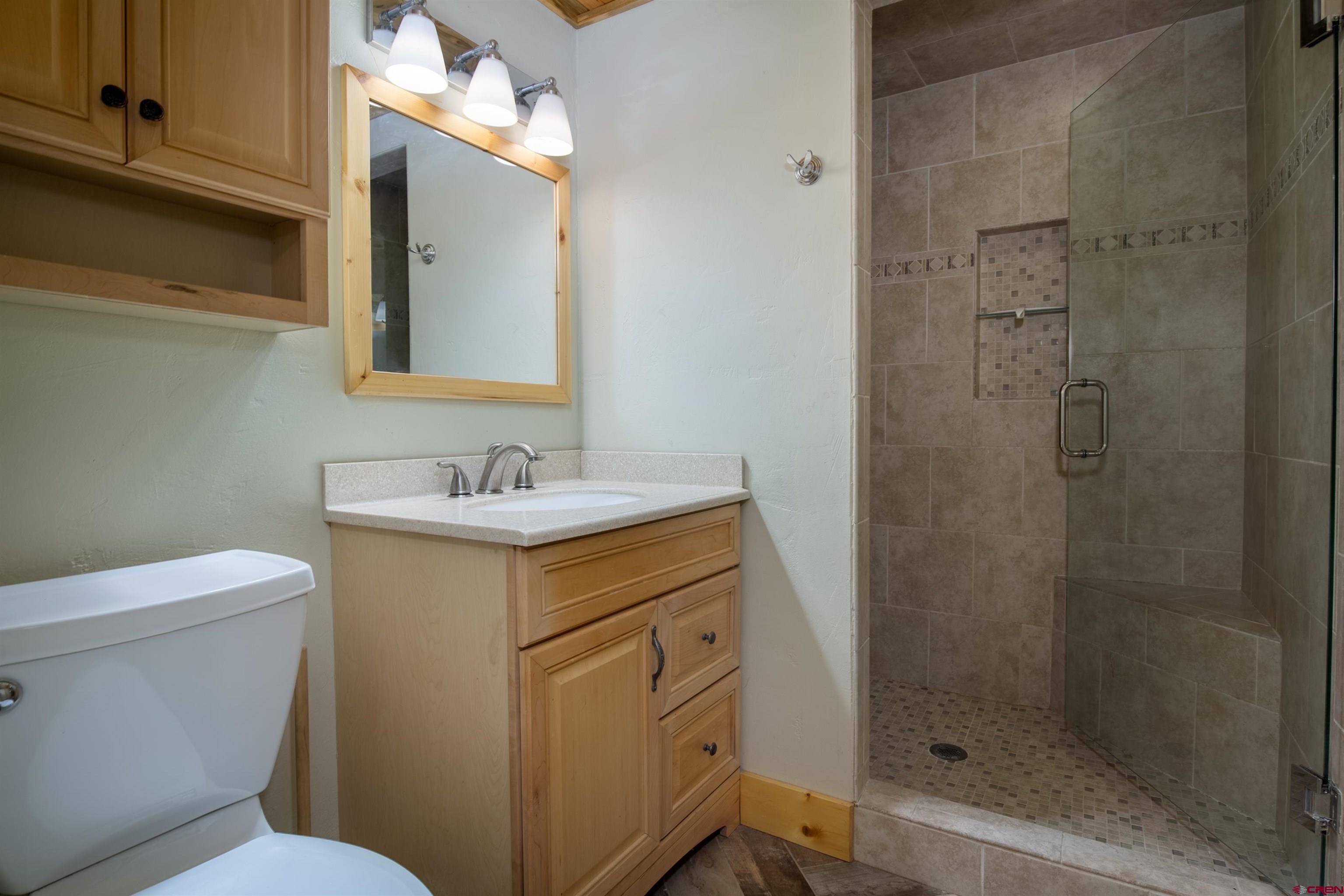 15 Debby Way Gunnison, CO 81230 - Photo 25 of 34 a bathroom with a sink toilet and shower