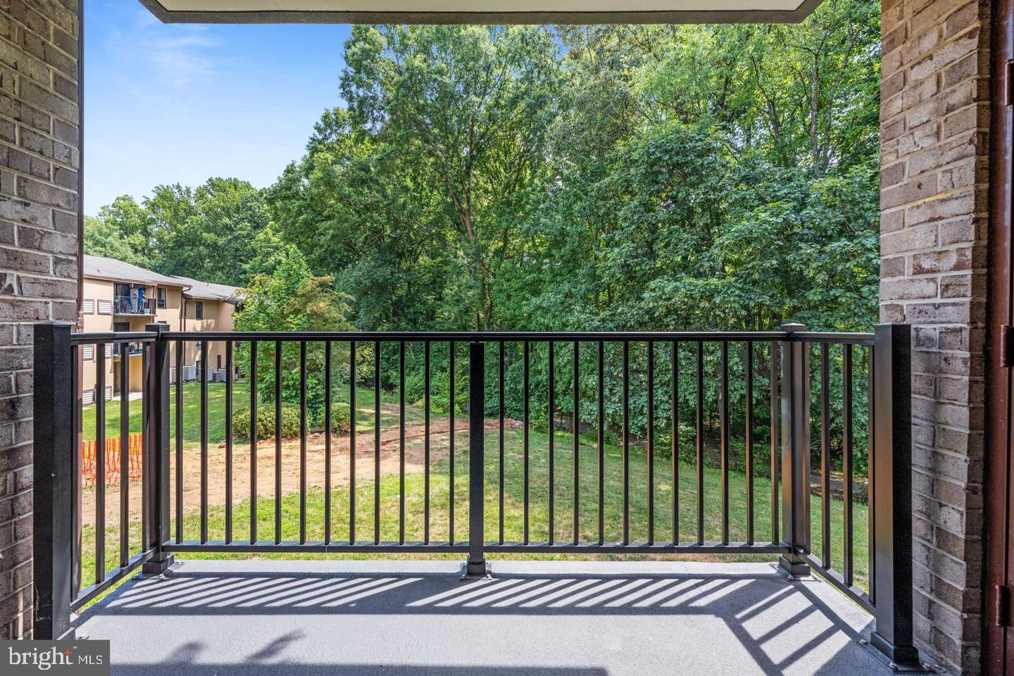 11659 Stoneview Square, Unit 11C Reston, VA 20191 - Photo 26 of 32 Serene balcony with lush greenery view.