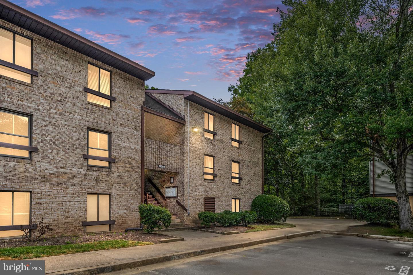 11659 Stoneview Square, Unit 11C Reston, VA 20191 - Photo 29 of 32 Charming brick apartment at dusk.