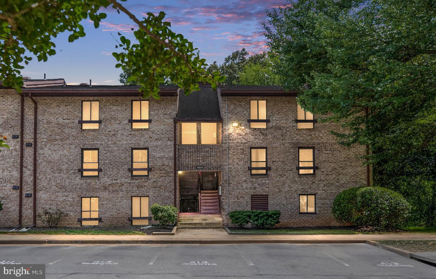 11659 Stoneview Square, Unit 11C Reston, VA 20191 - Photo 4 of 32 Charming brick apartment at dusk.