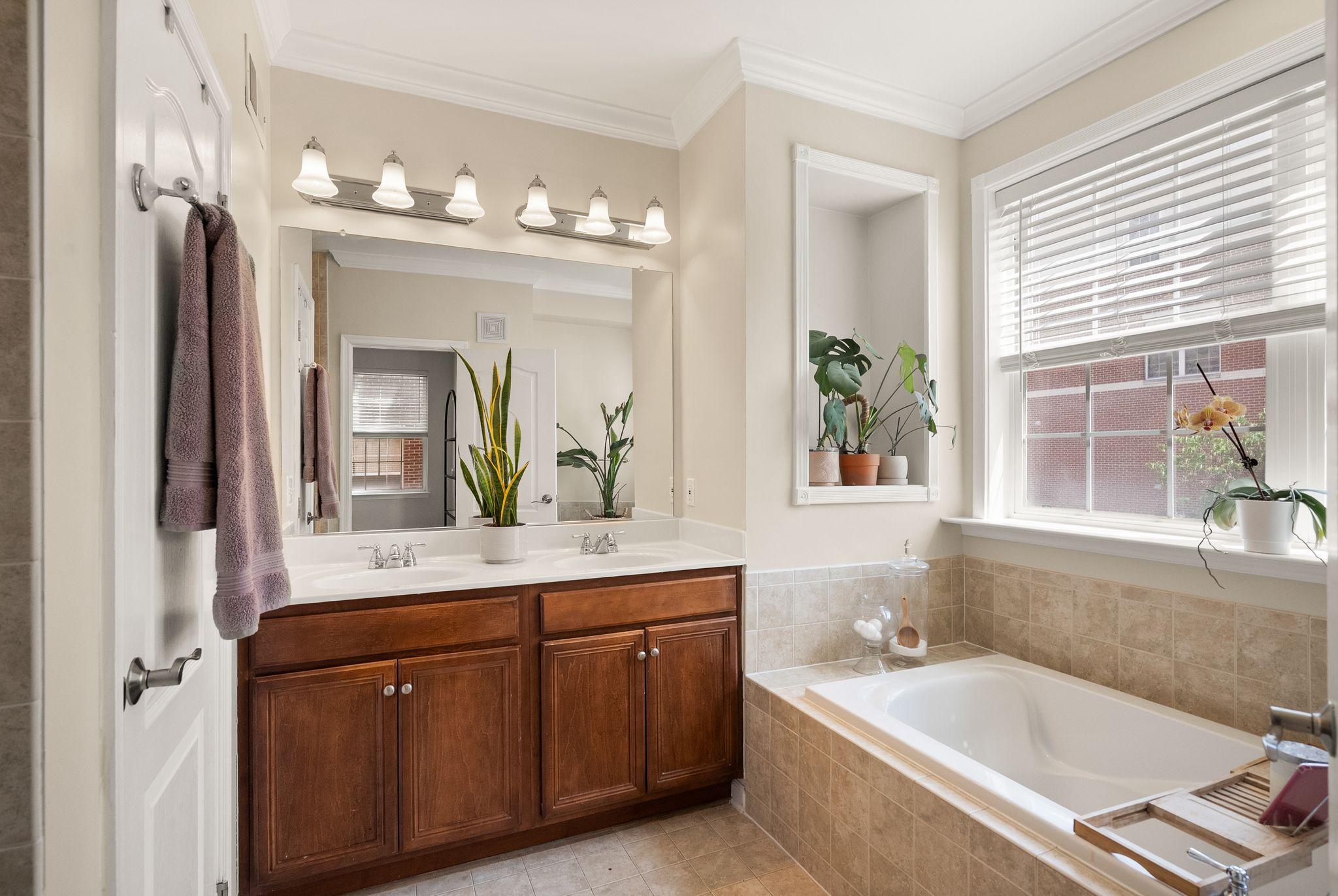 12414 A Liberty Bridge Road Fairfax, VA 22033 - Photo 21 of 38 a spacious bathroom with a tub sink and mirror