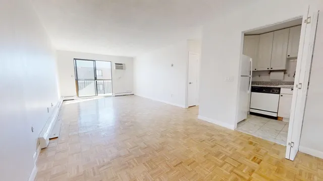 an empty room with cabinet and stainless steel appliances