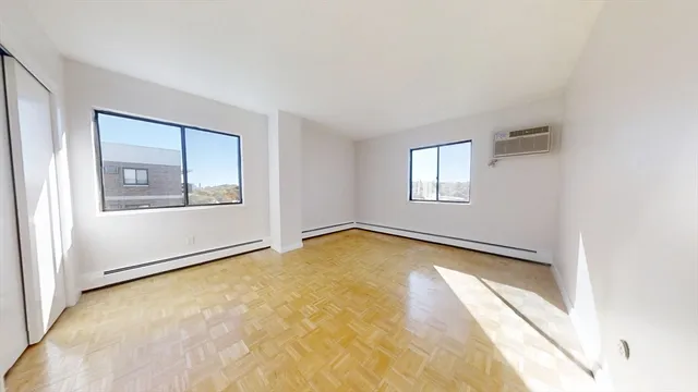 an empty room with windows and closet