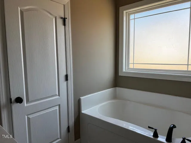 a white bath tub sitting next to a window
