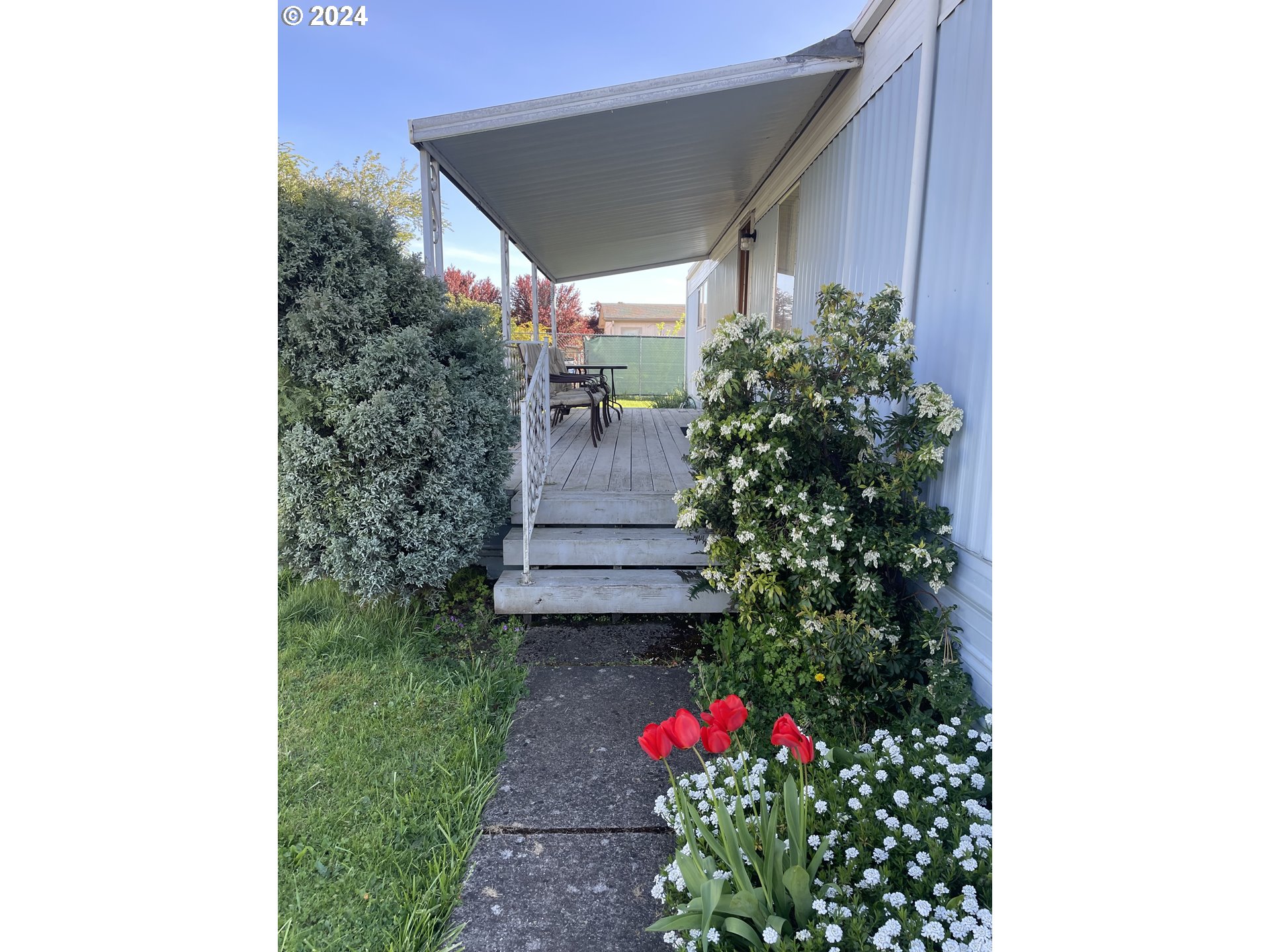 2150 Laura Street, Unit 31 Springfield, OR 97477 - Photo 3 of 19 a view of a house with a flower garden