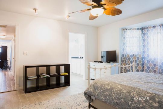 823 North Fairview Street Ridgecrest, CA 93555 - Photo 16 of 35 a bedroom with a bed and a flat screen tv