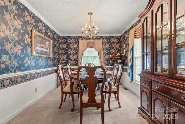 a view of a dining room with furniture window and chandelier