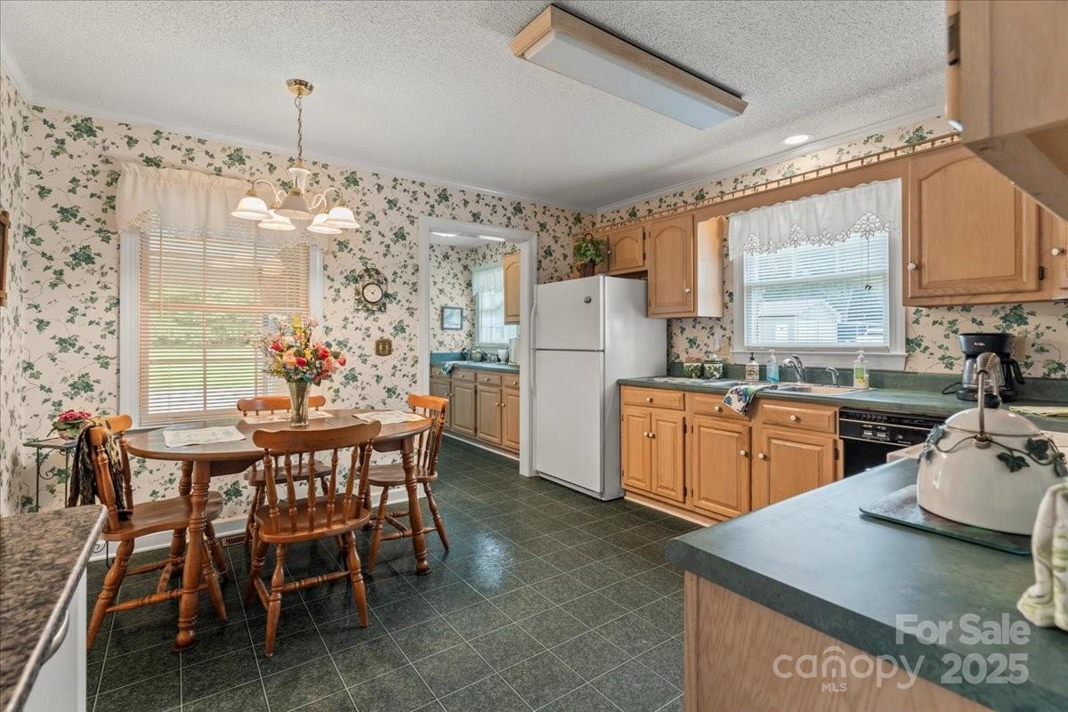 332 Ridge Road Cheraw, SC 29520 - Photo 14 of 46 a kitchen with stainless steel appliances kitchen island granite countertop a table chairs sink and cabinets
