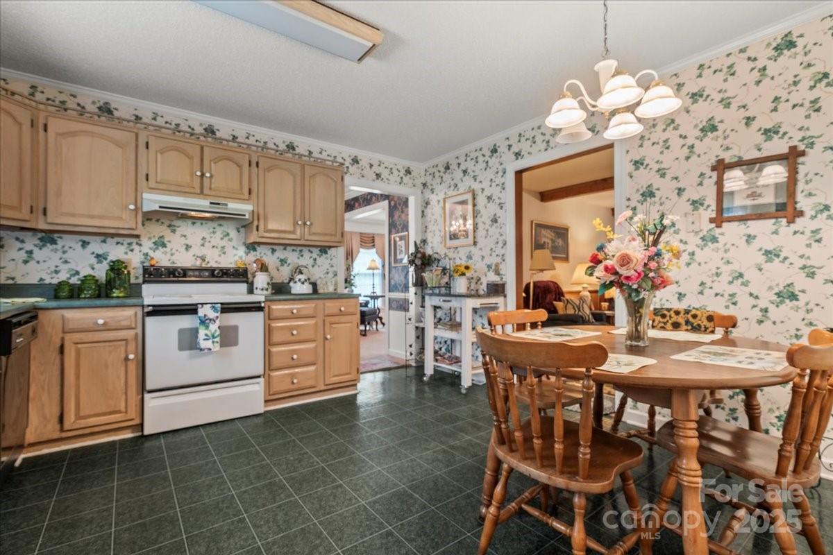332 Ridge Road Cheraw, SC 29520 - Photo 22 of 46 a kitchen with stainless steel appliances kitchen island granite countertop a table chairs sink and cabinets