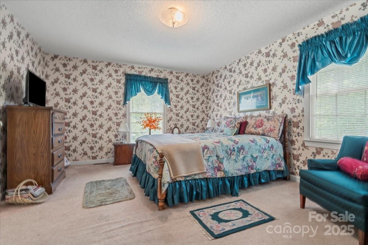 332 Ridge Road Cheraw, SC 29520 - Photo 32 of 46 a bedroom with a bed table and a flat screen tv