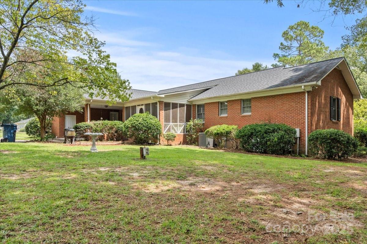 332 Ridge Road Cheraw, SC 29520 - Photo 5 of 46 a house that has a big yard and potted plants in front of it