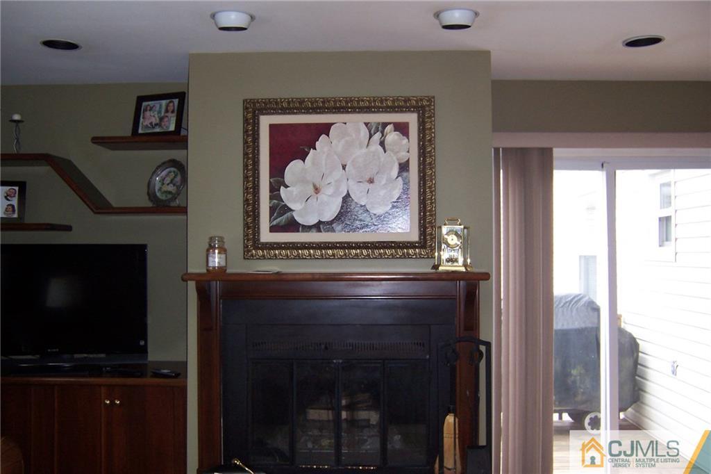 175 Midfield Road Colonia, NJ 07067 - Photo 11 of 25 a view of a livingroom with furniture and a fireplace