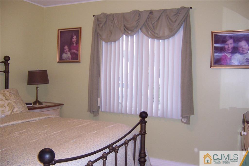 175 Midfield Road Colonia, NJ 07067 - Photo 13 of 25 a bedroom with a bed and a table in it