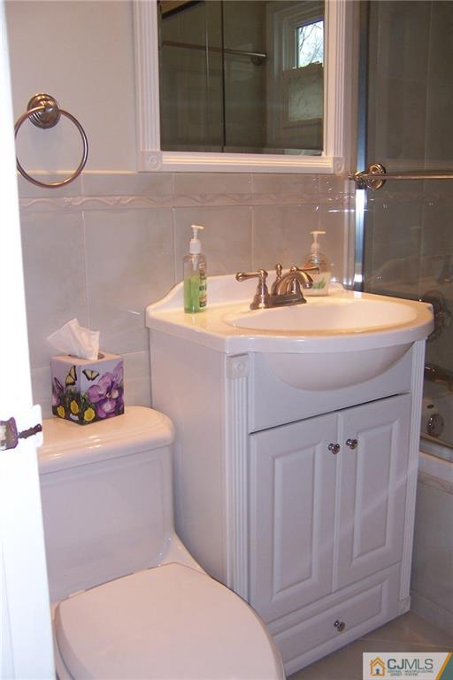 175 Midfield Road Colonia, NJ 07067 - Photo 19 of 25 a bathroom with a sink a toilet and mirror