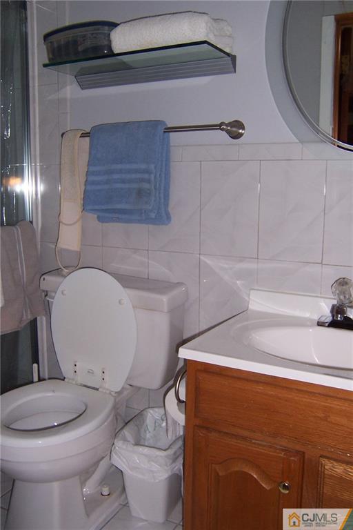 175 Midfield Road Colonia, NJ 07067 - Photo 23 of 25 a white toilet sitting next to a bathroom sink
