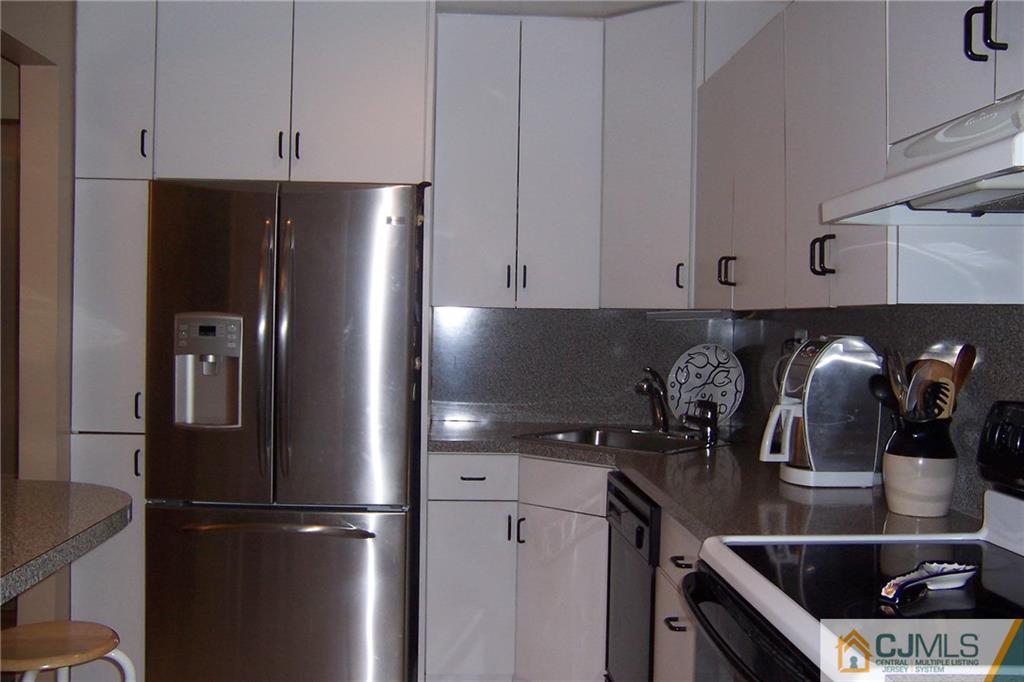 175 Midfield Road Colonia, NJ 07067 - Photo 6 of 25 a kitchen with granite countertop stainless steel appliances and refrigerator
