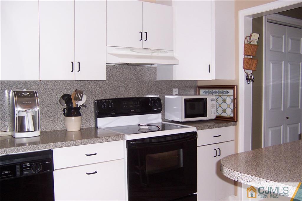 175 Midfield Road Colonia, NJ 07067 - Photo 7 of 25 a kitchen with stainless steel appliances granite countertop a sink stove and cabinets