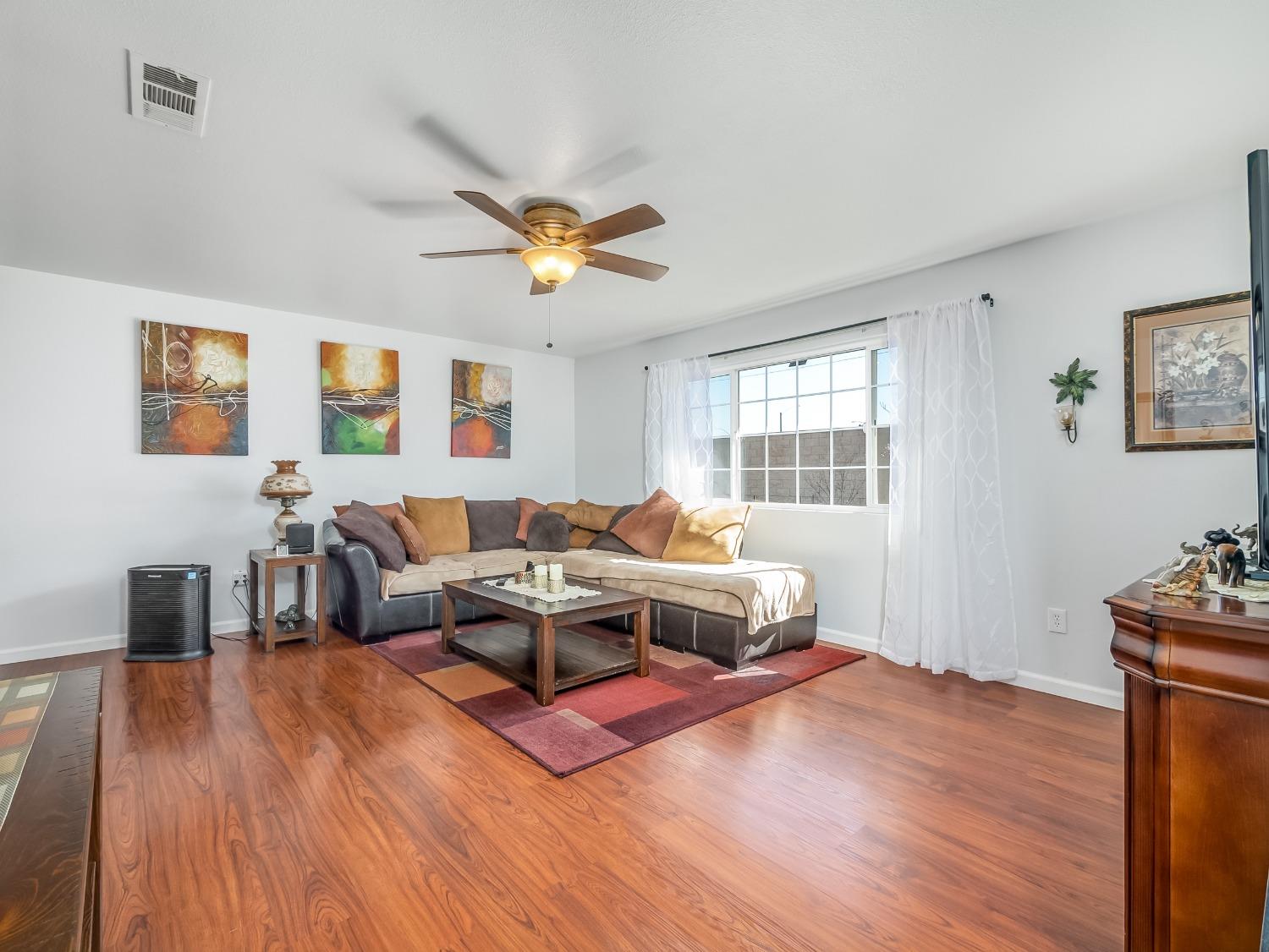65 West Spring Lane Lemoore, CA 93245 - Photo 7 of 28 a living room with furniture window and wooden floor