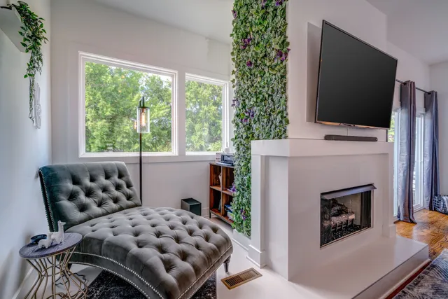 a living room with a large window and a flat screen tv