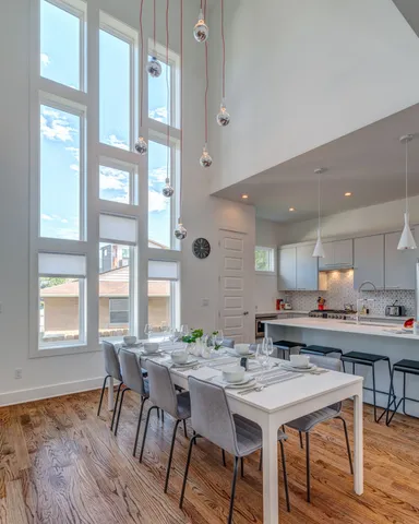 a view of a a dining room with furniture window and wooden floor