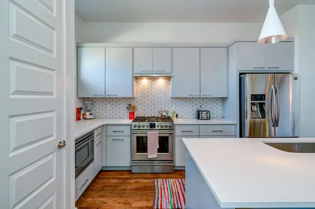 a kitchen with a white cabinets and white appliances