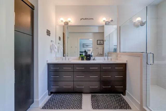 a bathroom with a shower a sink and a mirror