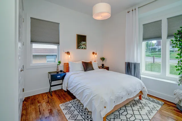 a bedroom with a bed and a window