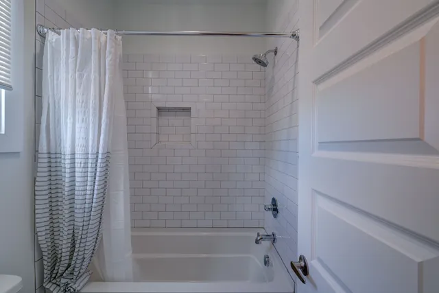 a bathroom with a shower and a bath tub