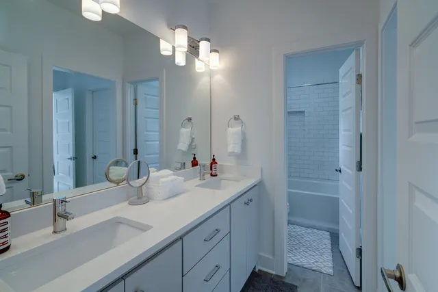 a bathroom with double vanity sink and a mirror