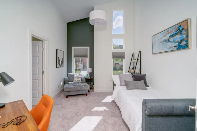 a bedroom with furniture and wooden floor