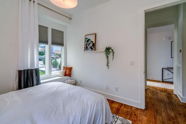 a bedroom with a bed and a window